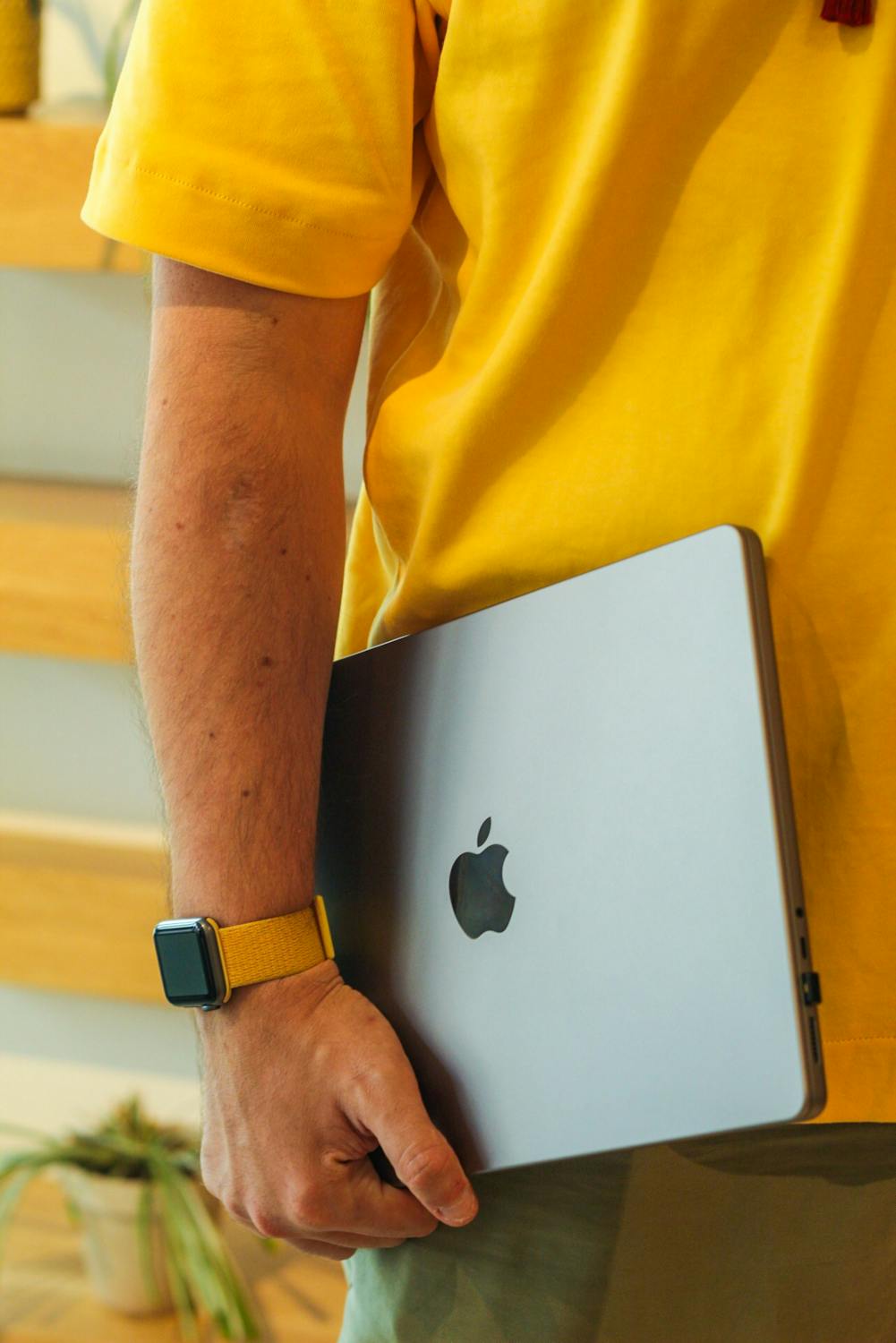 free photo of man with smart watch holding laptop